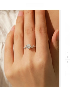 Close-up of 1 carat moissanite silver ring featuring elegant six-prong floral design on hand