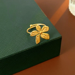 Detailed macro view of an adjustable gold flower ring with intricate petal textures