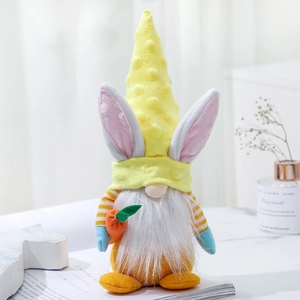 Easter gnome plush with yellow pointed hat and pink rabbit ears holding a carrot