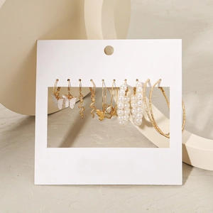 6-pair gold earring set with acrylic butterflies, snakes, and faux pearls on display