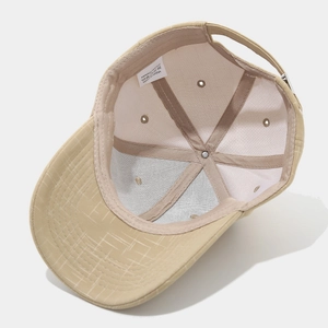 Detail of beige baseball cap interior showing reinforced seams and polyester fabric label