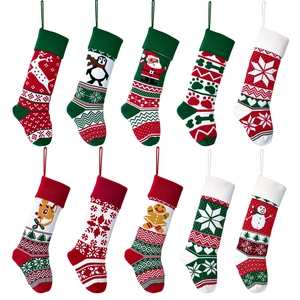 Macro view of knit Christmas stockings with snowflake embroidery in red and green colors