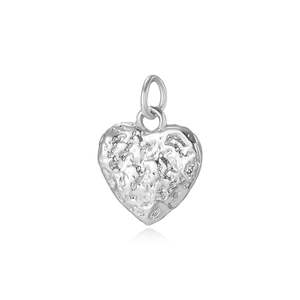 Close-up of a silver heart pendant with unique hammered texture and a metallic polished finish