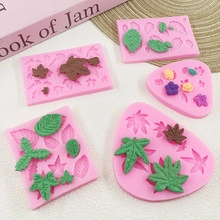 Detailed view of pink silicone leaf and flower molds with green fondant leaf examples