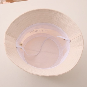 Detailed interior of a beige kids bucket hat with mesh lining and chin strap