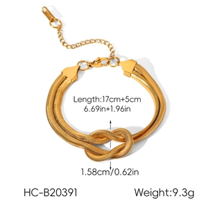 Macro detail of 18k gold plated snake chain bracelet with elegant knot design