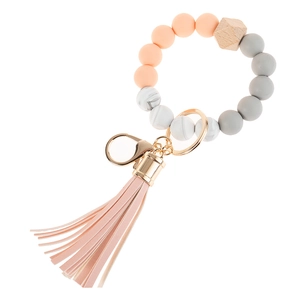 Close-up of silicone beaded wristlet keychain with pink leather tassel and gold ring