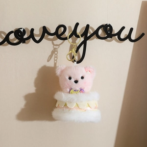 Pink plush bear pendant in cake tutu dress hanging on hook for bag keychain ornament