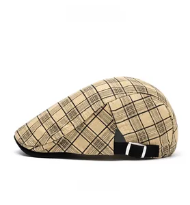 Detail view of khaki plaid newsboy cap showing the black adjustable strap and metal buckle