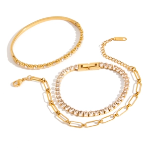 Gold stainless steel heart bracelet set featuring rhinestone tennis and paperclip chains