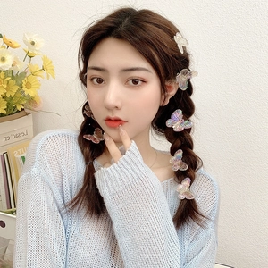 Colorful gradient butterfly hair clips set worn on a girl's braided hairstyle
