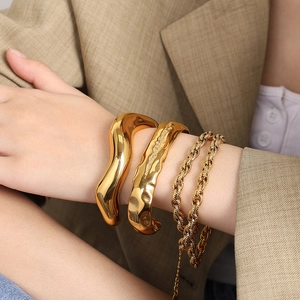 Lava texture gold cuff bracelet set for women featuring irregular molten metal design