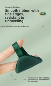 Macro detail of dark green triangular makeup puff with silky ribbon handle for precise use