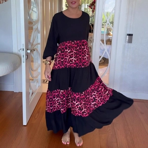 Detail of elegant leopard print patchwork maxi dress in black and hot pink tones