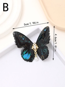 Detail showing the 5cm butterfly hair clip with blue enamel, crystals and pearl drop
