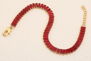 Detailed close-up of 18K gold plated bracelet with rectangular red zircon stones