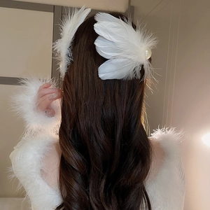Elegant white feather pearl hair clip shown on wavy hair from a back perspective