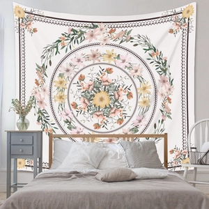Detailed view of bohemian floral mandala tapestry hanging in a cozy bedroom setting