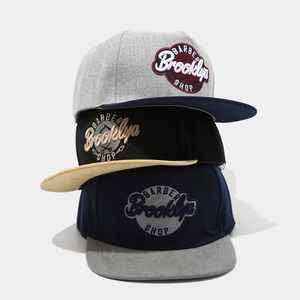 Three stylish color-block snapback hats with Barber Brooklyn Shop vintage embroidery