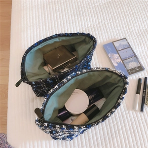 Macro view of blue tweed makeup bags showing large capacity for skincare and cosmetics