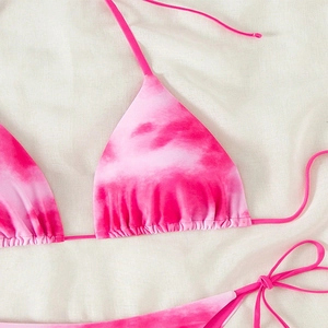 Detailed view of pink tie-dye bikini top with gathered fabric and delicate neck ties