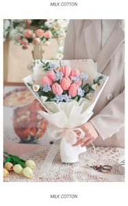 Handcrafted pink and blue milk cotton crochet tulip bouquet held in a cozy home setting