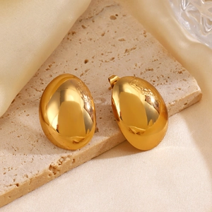 Elegant gold oval stud earrings with polished finish on a minimalist stone display
