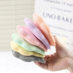 Close-up of six colorful shell-shaped sponges showing soft porous texture and vibrant tones