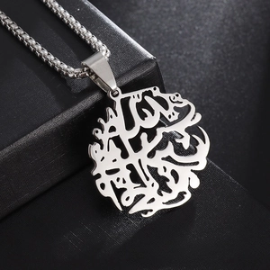 Detail showing an Arabic calligraphy tree of life pendant on a black leather box