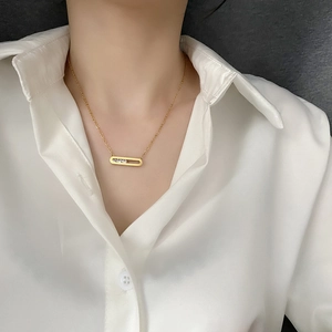 Minimalist 18K gold plated necklace featuring a horizontal oval pendant with three zircons