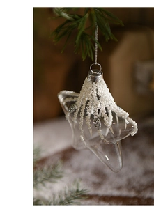 Macro detail of star glass Christmas ornament with white beads and silver rhinestones