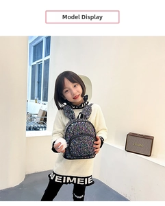 Detailed view of kids sequin backpack with cute rabbit ears and a soft white pompom charm