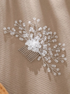 Detailed close-up of handmade bridal hair comb with silver wire and crystal beads