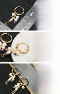 Detailed view of handmade baroque pearl earrings with 18K gold plated weaving and gemstones