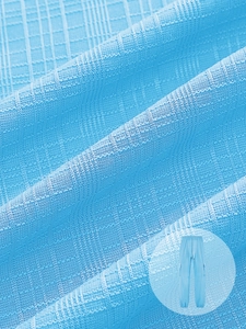 Close-up of light blue cargo pants showing the detailed waffle texture fabric and drawstring