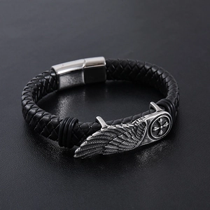 Men's braided leather bracelet with silver wing charm and cross motif, magnetic clasp