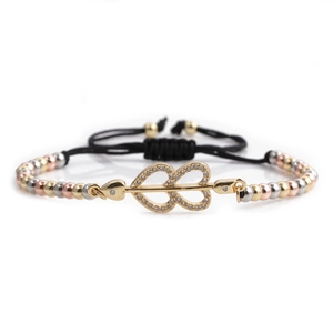 Detail of heart and infinity charm with cubic zirconia on tri-color beaded bracelet