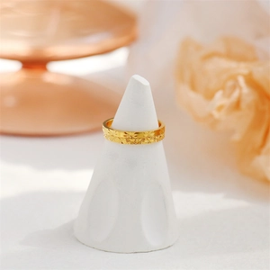 Detailed macro shot of 18K gold plated steel ring with precision starburst floral engraving