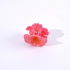 Detailed view of a 4.5cm pink camellia flower hair claw clip on a white background