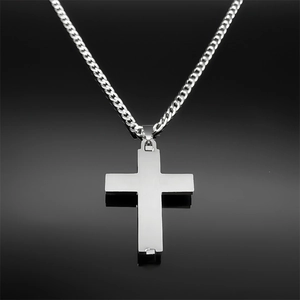 Detailed close-up of silver stainless steel cross pendant with brushed metal texture