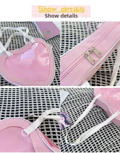 Close-up of pink heart-shaped ita bag showing PVC window, metal zippers and strap details