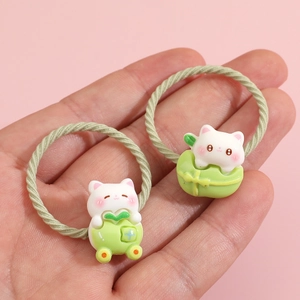 Cute cartoon cat and frog hair ties for girls on a soft pink background