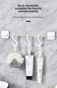 Detail showing rustproof S-shaped hooks on a white rod for kitchen and bathroom storage