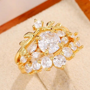 Three-piece gold plated ring set with leaf design and clear zircon stones in a jewelry box