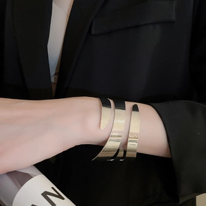 Polished silver geometric multi-layer spiral cuff bracelet shown on model's wrist
