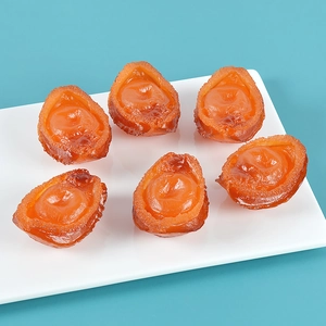 Top view of six realistic PVC fake abalone models on a white plate with blue background