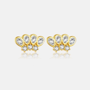 Detail view of gold crown earrings with teardrop and round cubic zirconia stones