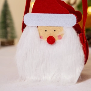 Close-up of Santa Claus felt gift bag with plush beard and festive holiday decorations