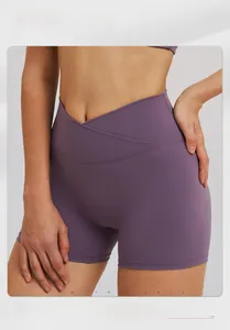 Detail showing cross-over V-waist design on purple high-waist yoga sports shorts