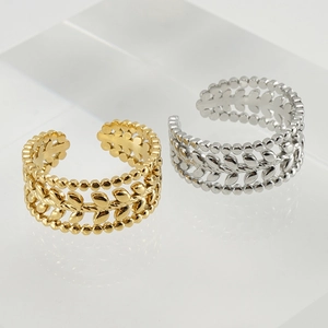Detailed view of vintage gold and silver leaf pattern adjustable open rings